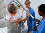 Nurse guiding a patient in a sling